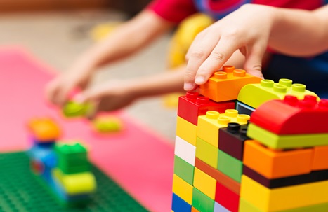 Close-up of child playing with lego