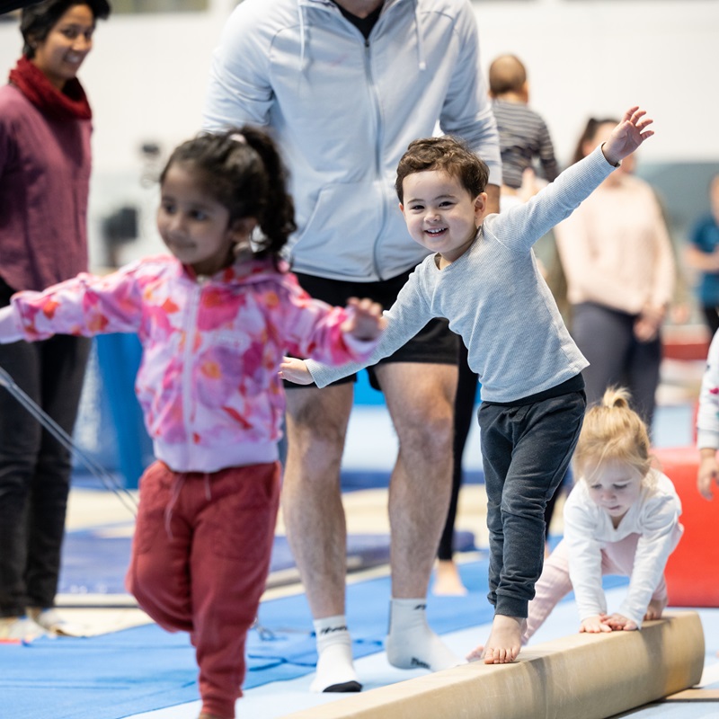 Young boy and girl walking on the balance beam