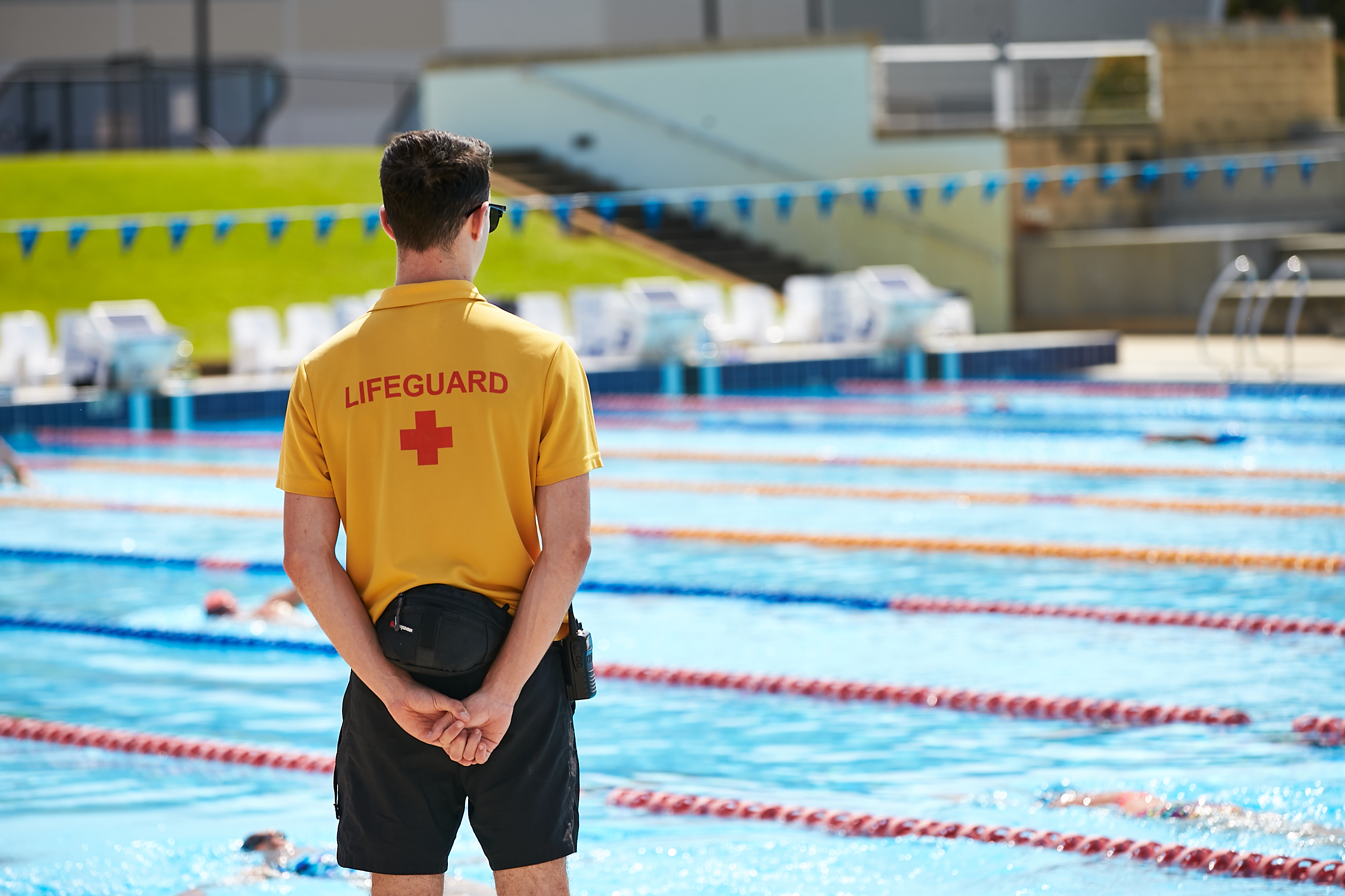 Lifeguard patrolling outdoor pool