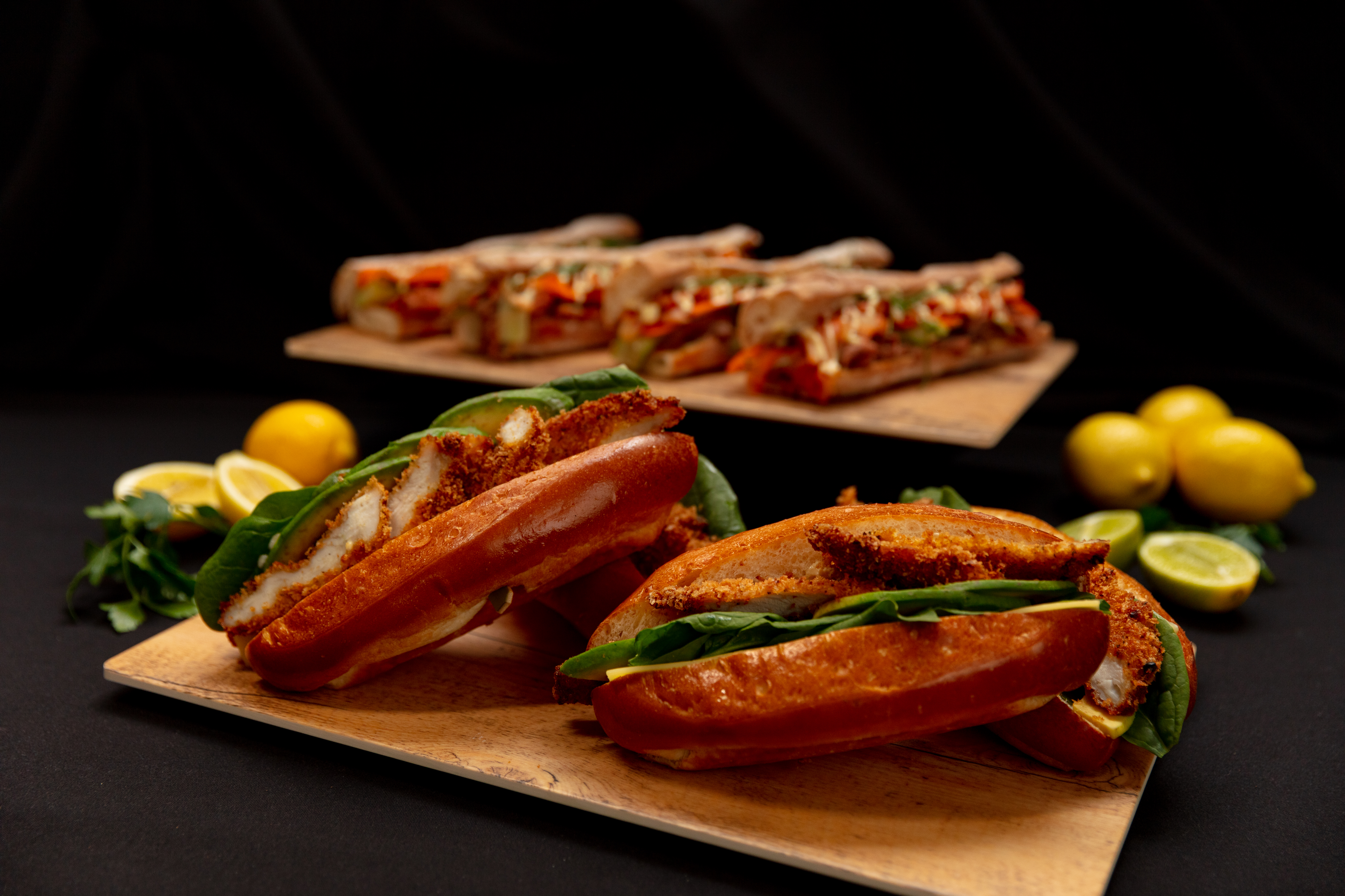 A staged photo of various sandwiches and food options posed