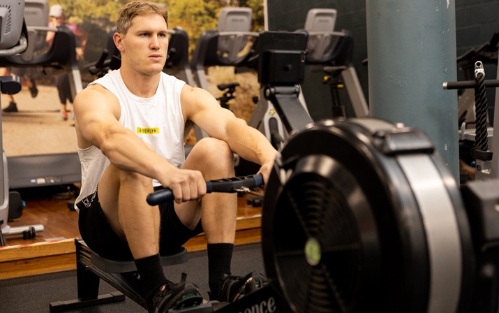 A photo of a gym attendant performing the Seated Row Workout