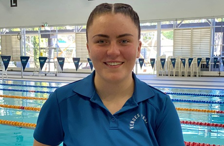 venueswest swim instructor smiling in front of lane pool